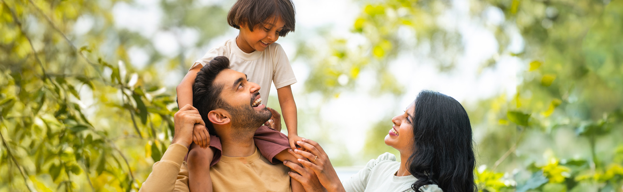 Indian parents playing with daughter, secured by insurance