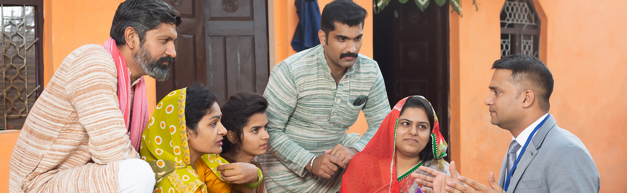 Rural family meeting bank manager for insurance